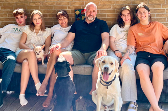 Patient sitting with family and two dogs