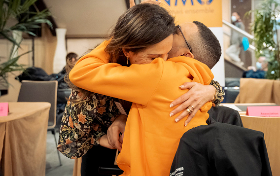hugging another patient in wheelchair